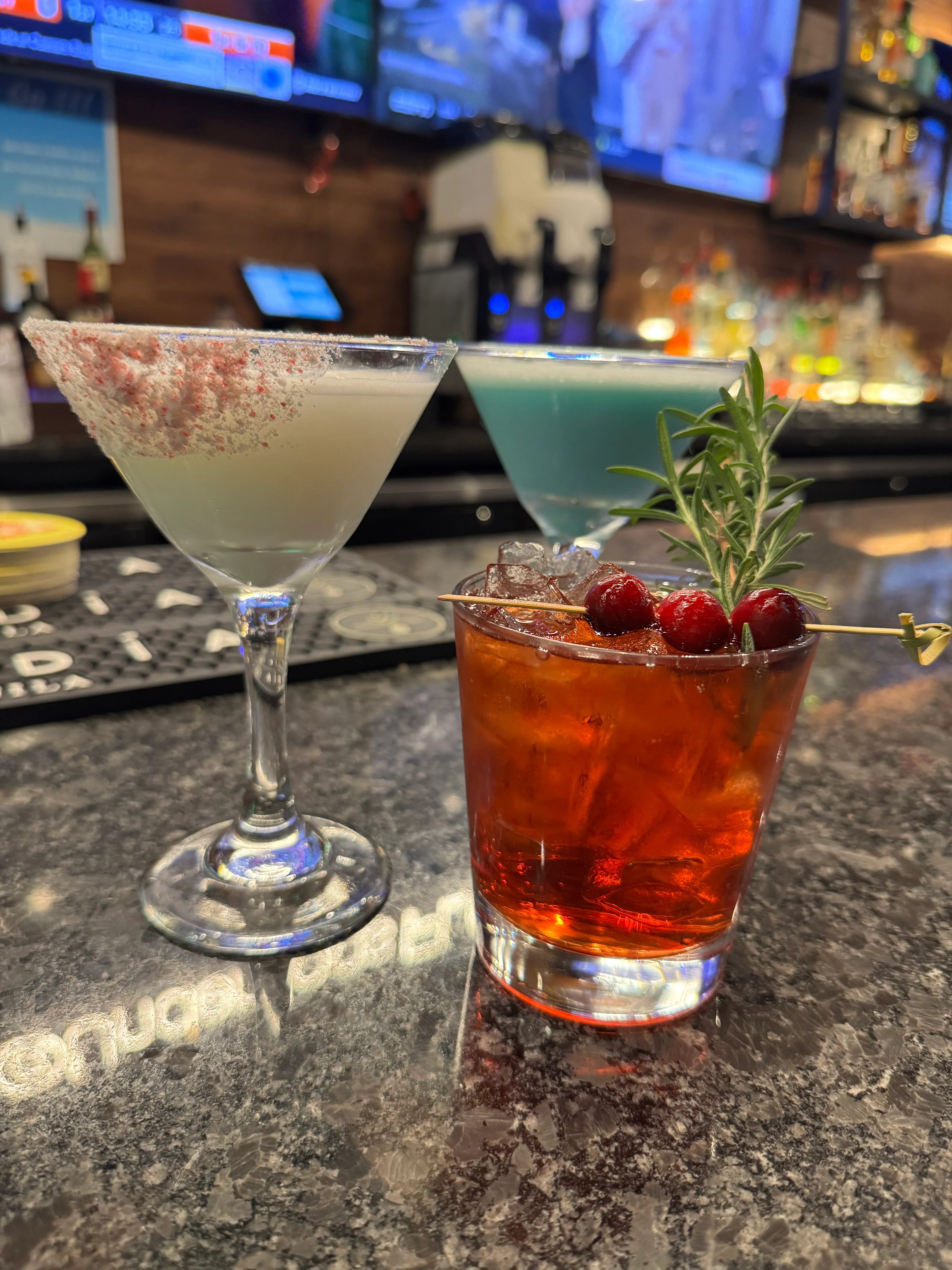 Colorful cocktails on a bar counter with garnishes