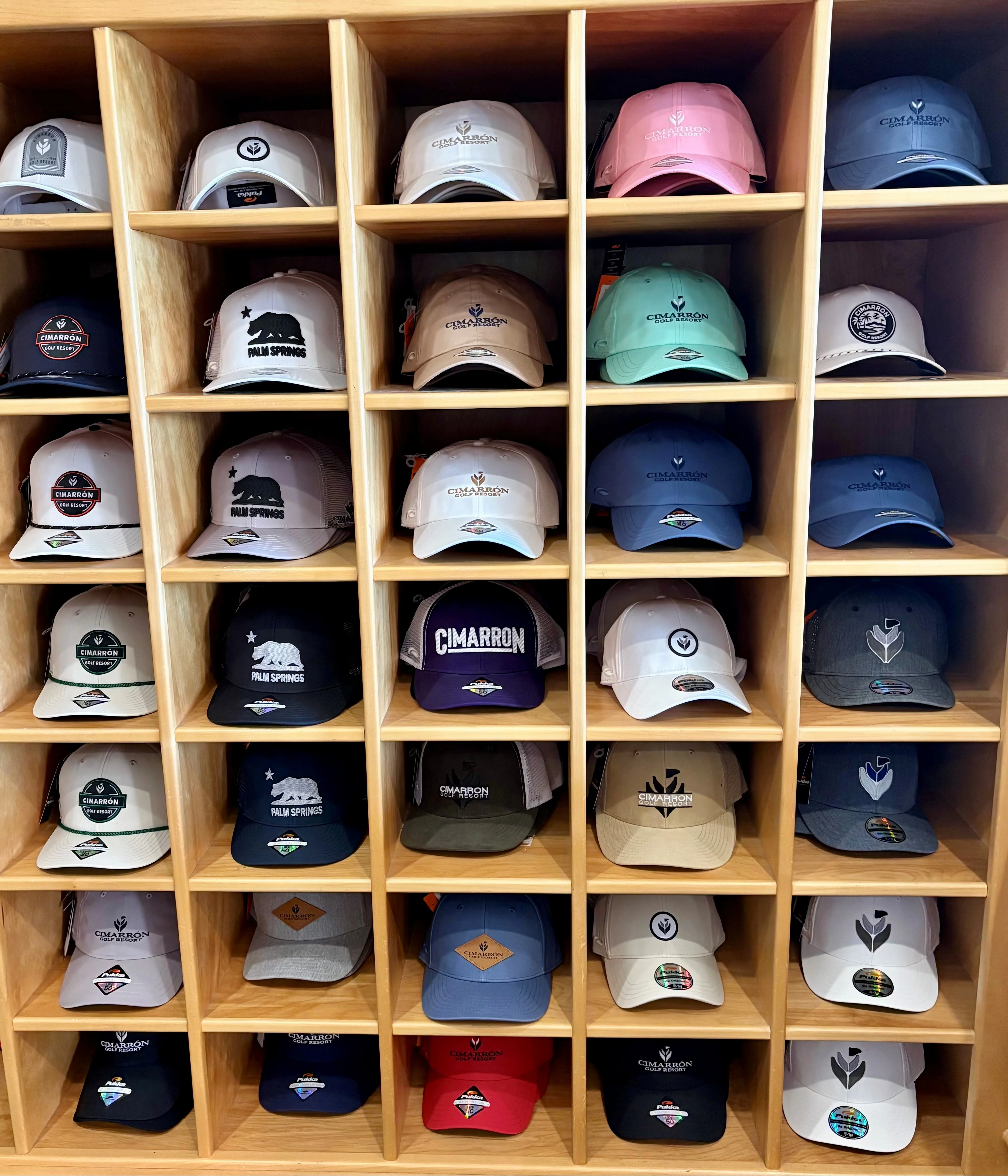 Display of various stylish hats on wooden shelves