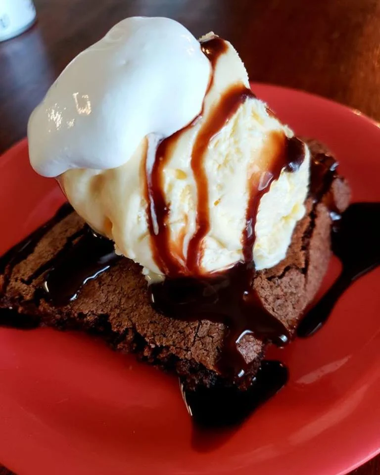 Decadent brownie sundae with vanilla ice cream and chocolate sauce