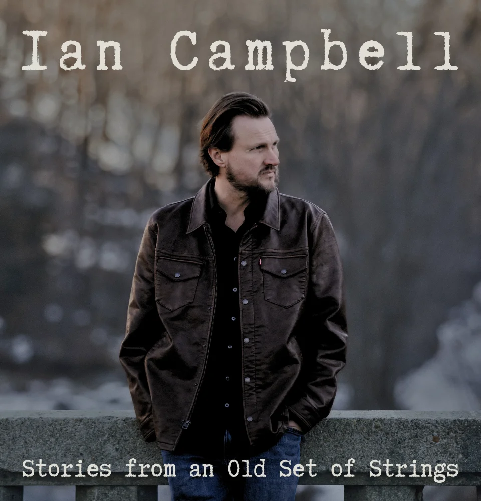 Musician Ian Campbell posing outdoors with a contemplative expression