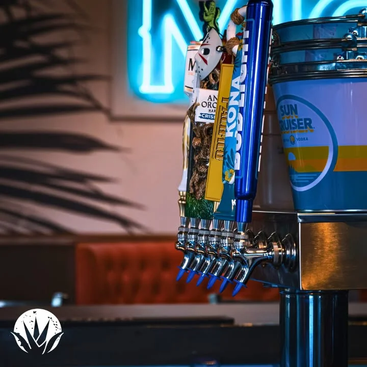 Craft beer taps with colorful handles at a modern bar counter