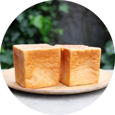 Japanese shokupan bread loaves on a wooden plate