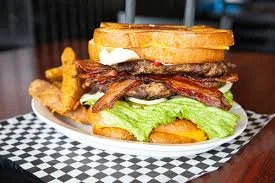Hearty American burger stacked with bacon and fresh lettuce