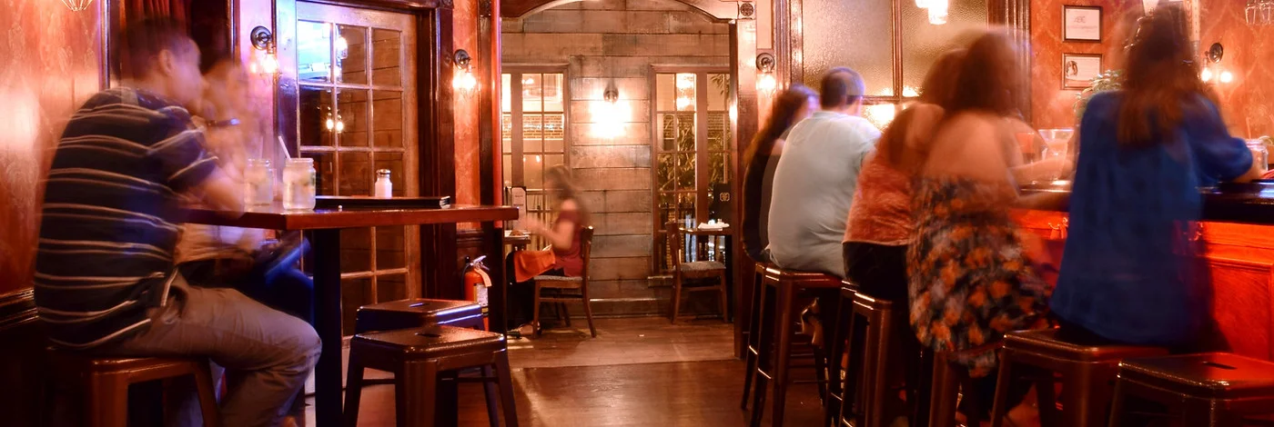 Cozy restaurant interior with warm lighting and bar seating