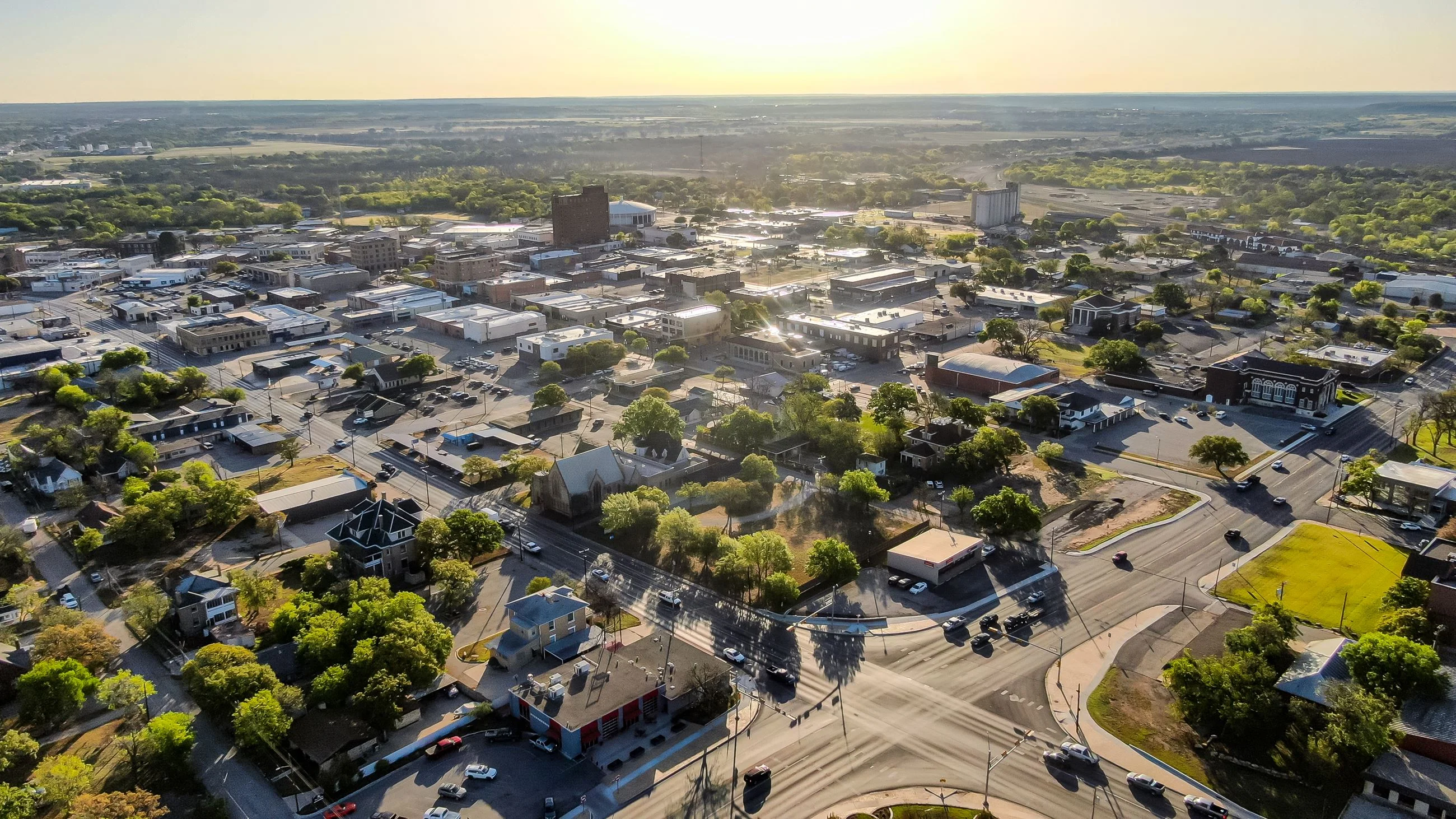 Aerial view of a vibrant small town with green trees and buildings