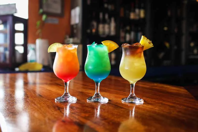 Colorful tropical cocktails on a wooden bar