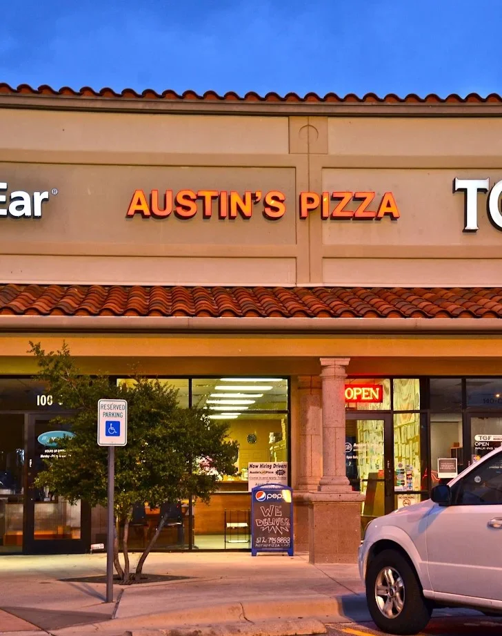 Exterior view of Austin's Pizza restaurant at dusk