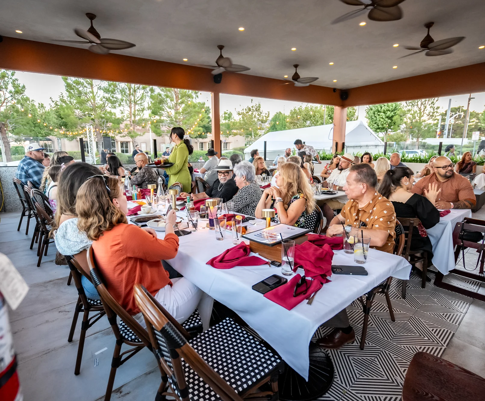 Lively restaurant patio filled with guests
