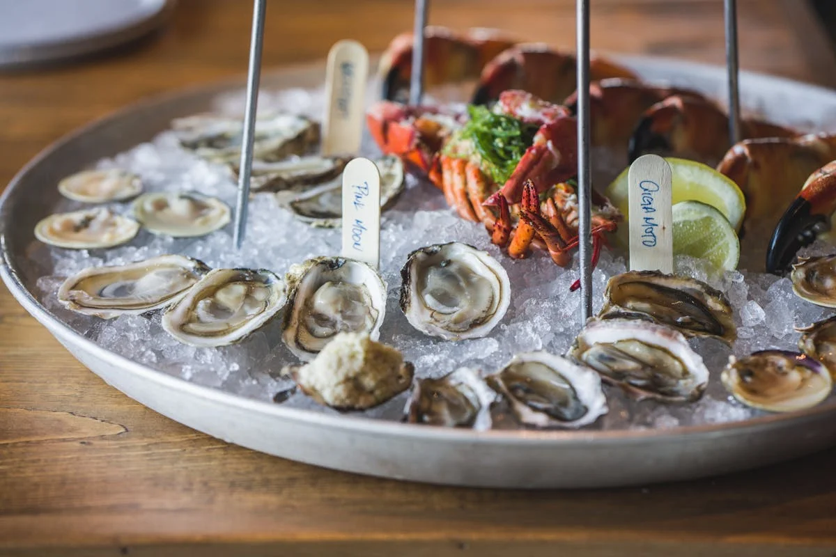 Seafood platter with oysters and lobster on ice