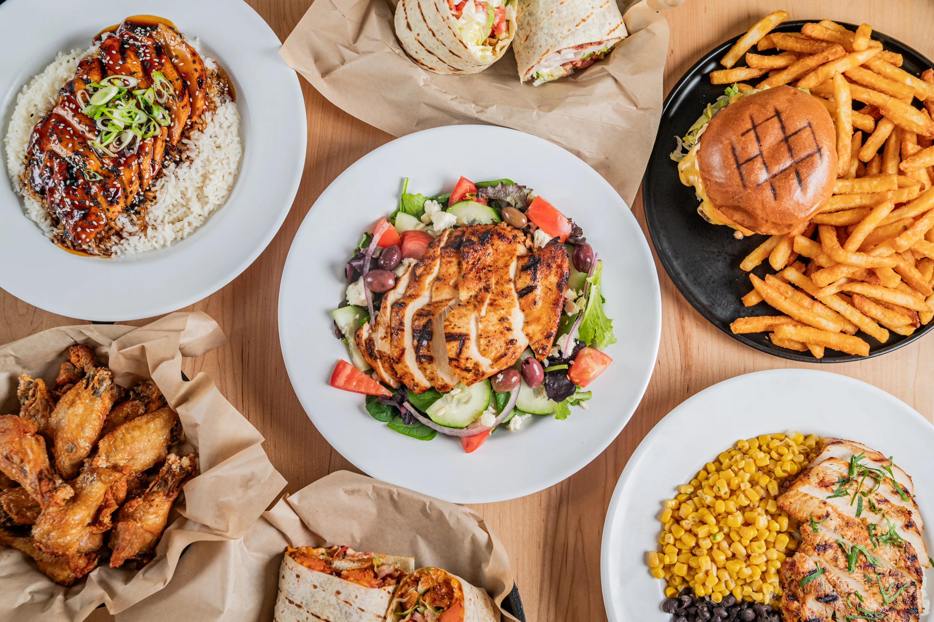 Grilled chicken salad with mixed greens and Mediterranean flavors