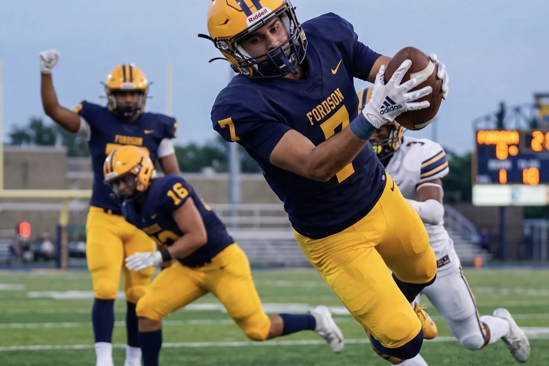 High school football player making a catch on the field