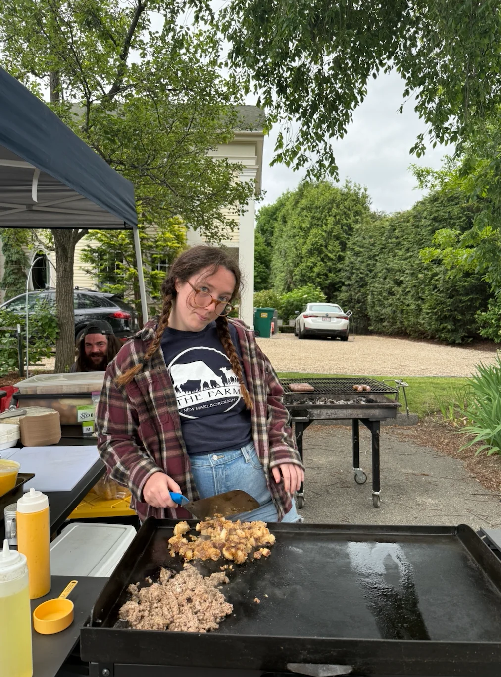 Two people in matching shirts at a farm market