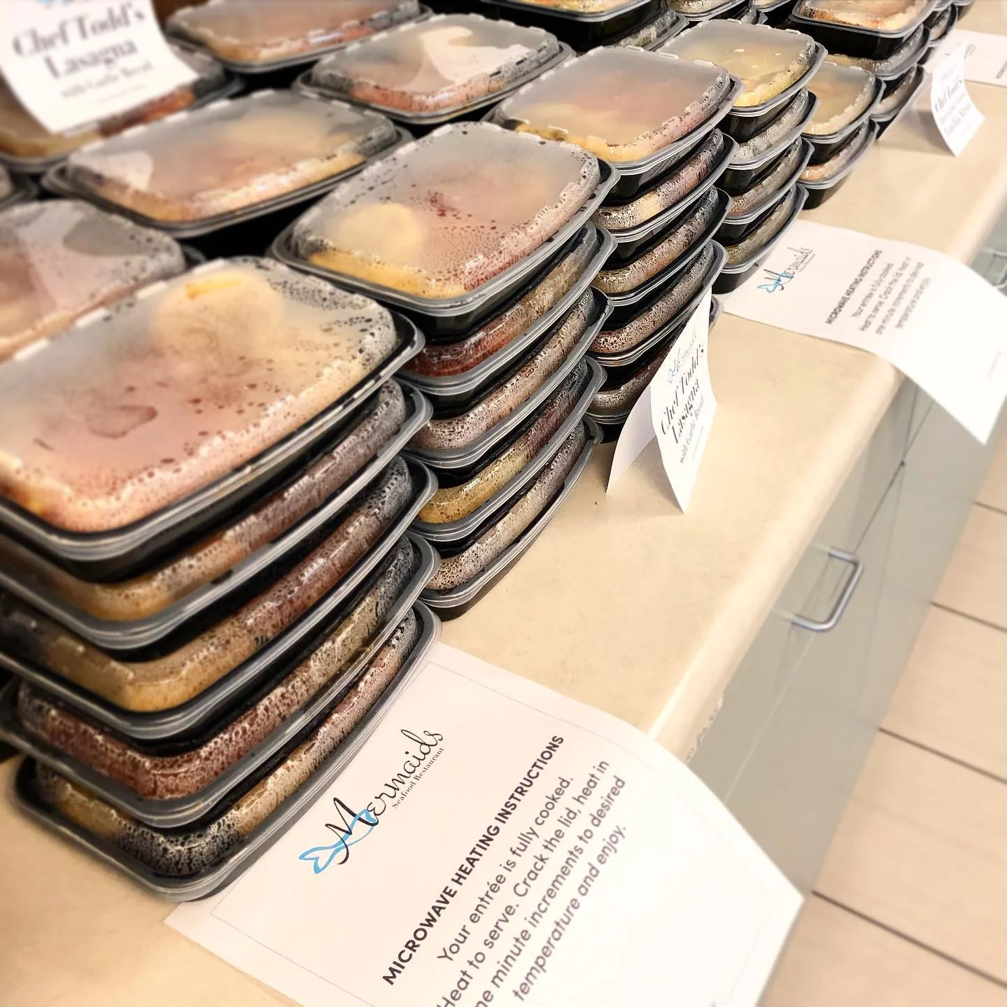 Multiple stacks of Diner Dash take and bake meals from Chef Todd with microwave heating instructions