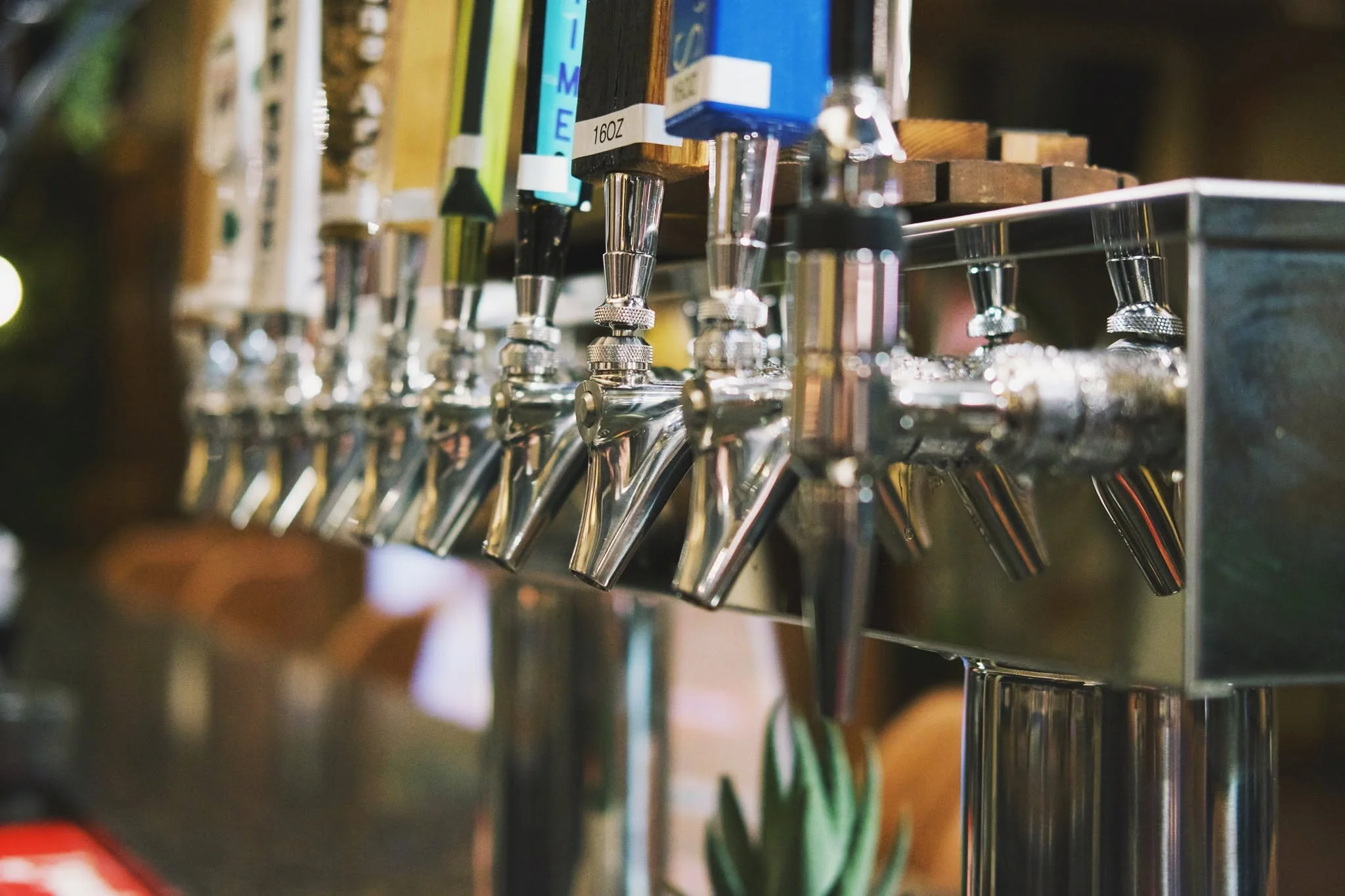 Craft beer taps lined up at a modern bar