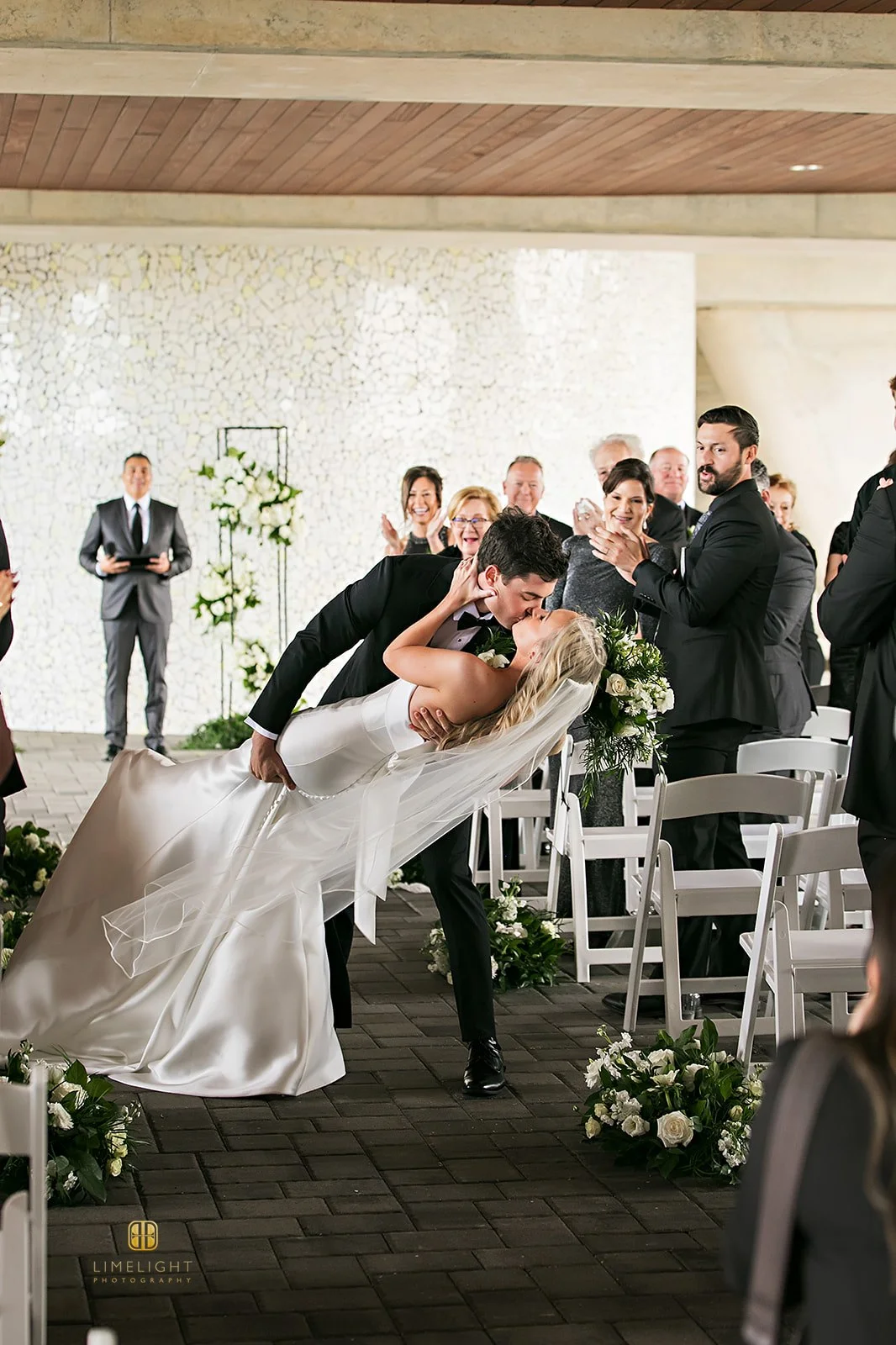 Couple sharing a romantic kiss at their wedding ceremony