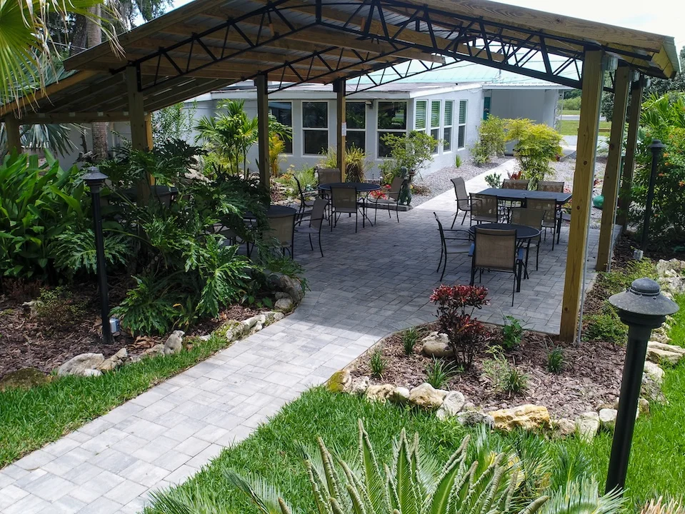 Outdoor dining area with lush greenery and seating