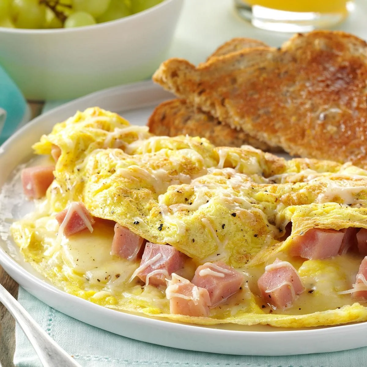 Classic ham and cheese omelette served with toast
