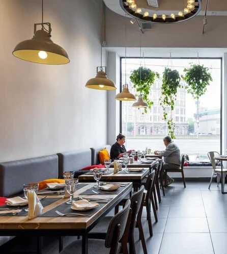 Modern restaurant interior with cozy seating and large windows
