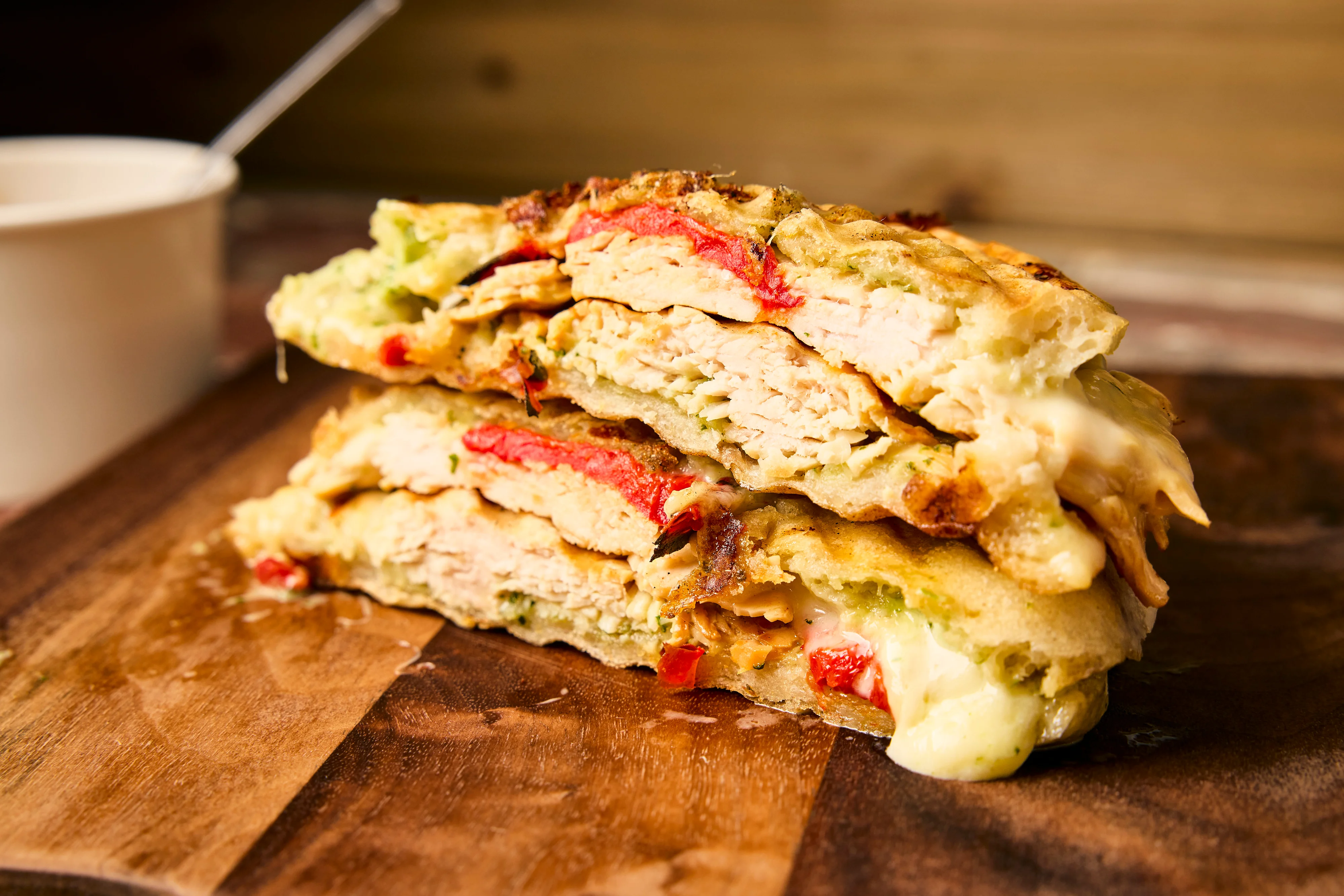 The Gio is a vegan sandwich with roasted zucchini, squash, carrots & mozza- rella with a walnut-red pepper pesto on grilled ciabatta.