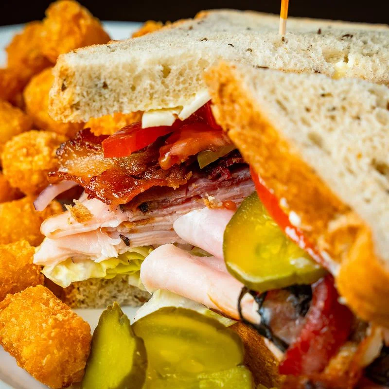 Delicious gourmet burger with fresh toppings on a wooden table