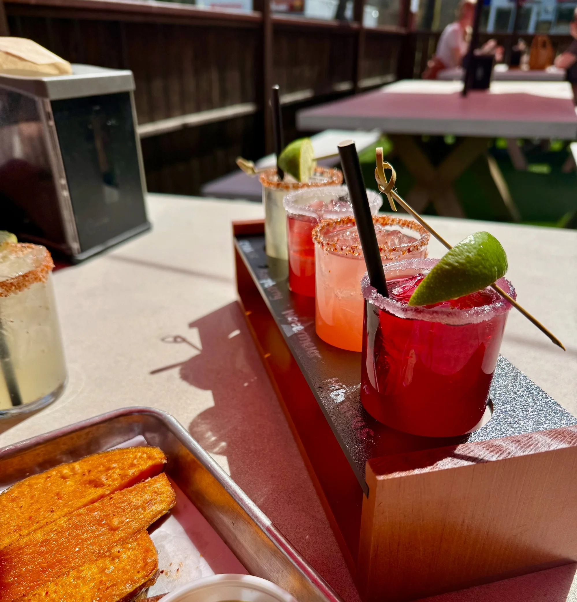 A margarita flight on the Brazos Taco Bar patio in Barracks Road Shopping Center