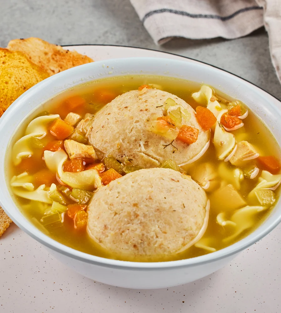 Chicken matzoh ball soup with noodles and vegetables