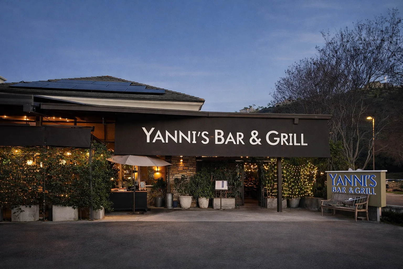 Exterior view of Yanni's Bar & Grill with warm lighting