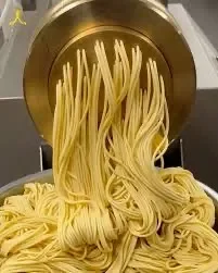 Freshly extruded spaghetti pasta ready for cooking