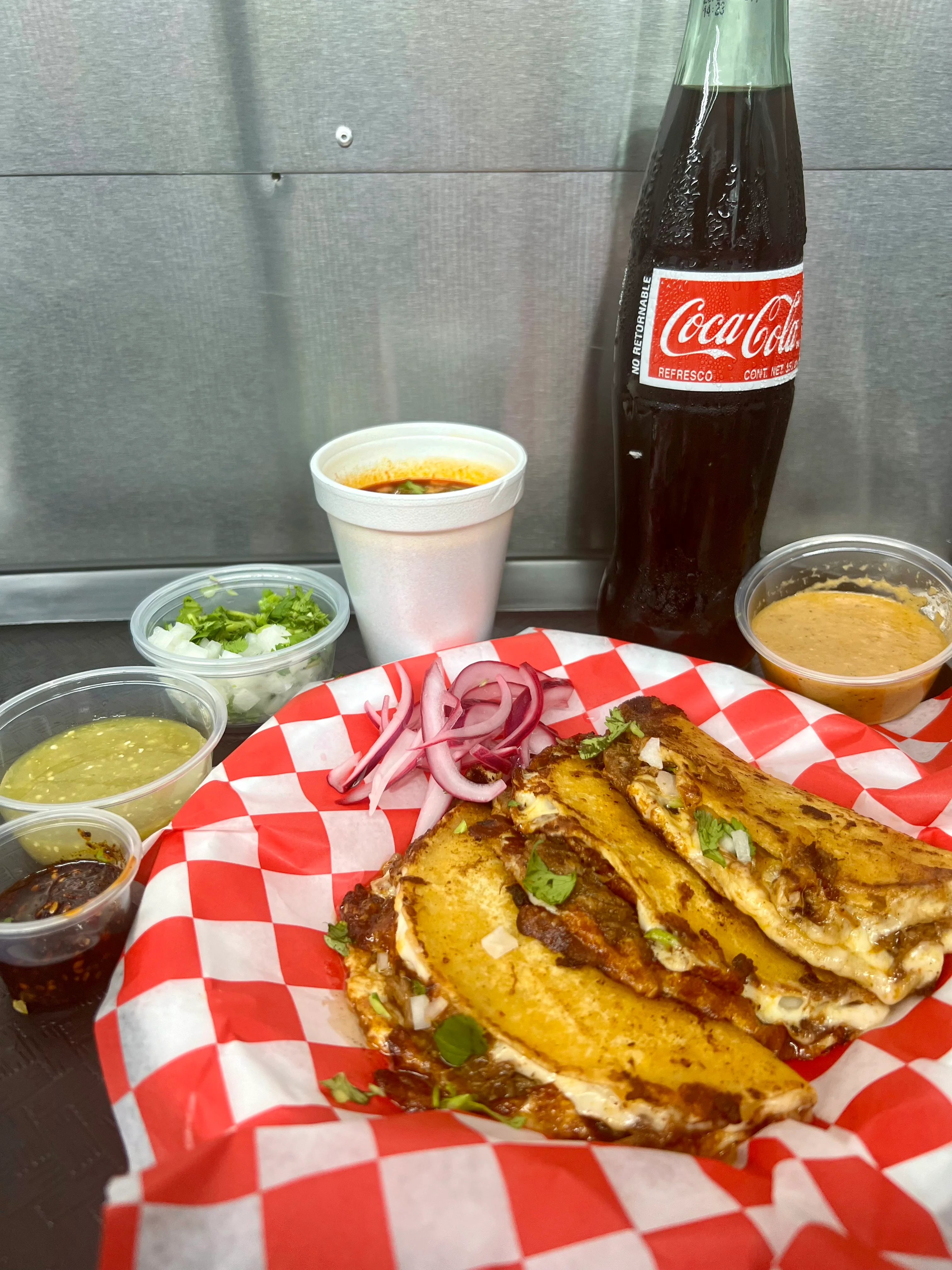Delicious Mexican tacos with salsas and a refreshing Coca-Cola