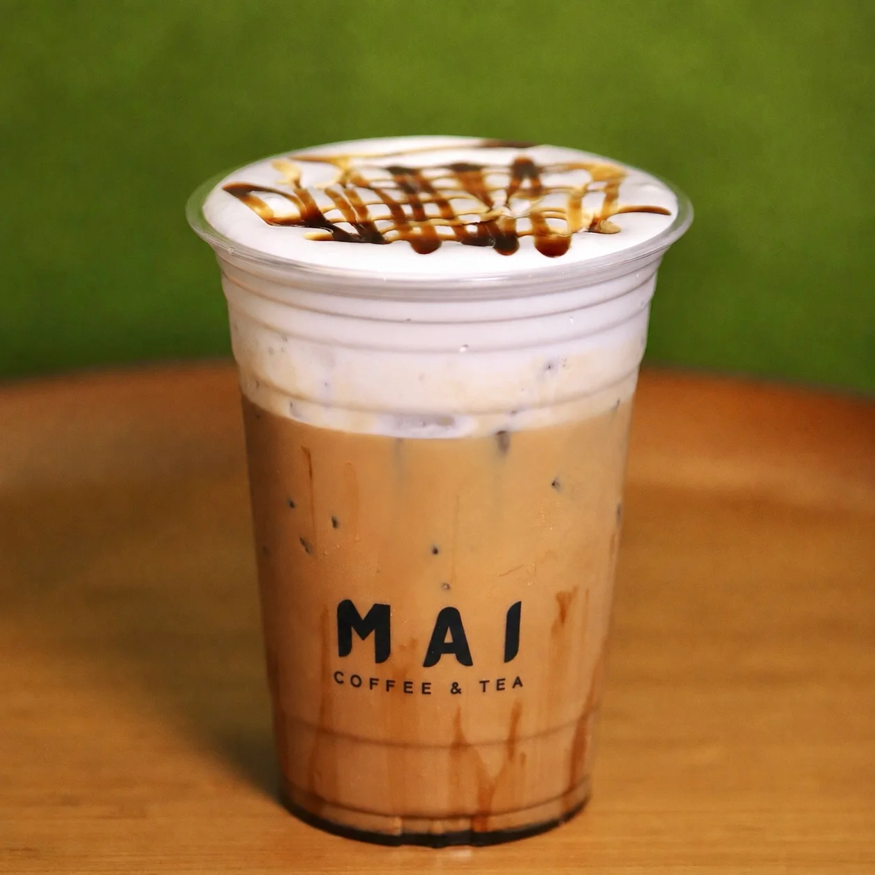 Iced coffee drink with creamy foam and caramel drizzle