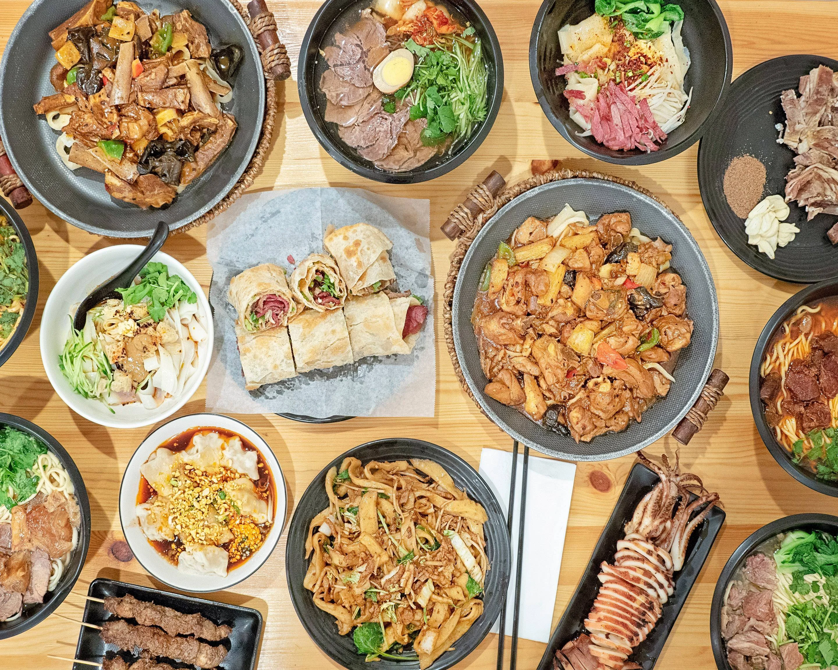Assorted Chinese dishes including stir-fried chicken and dumplings