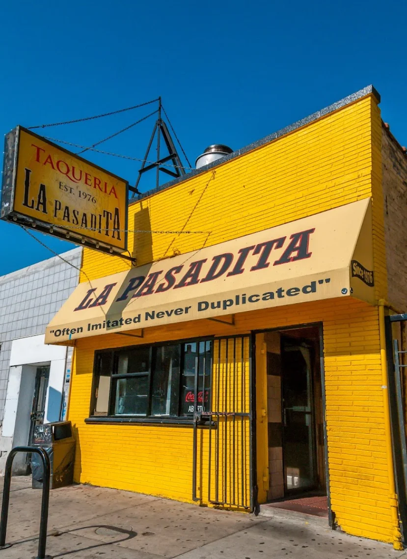 Exterior of La Pasadita taqueria with vibrant yellow facade