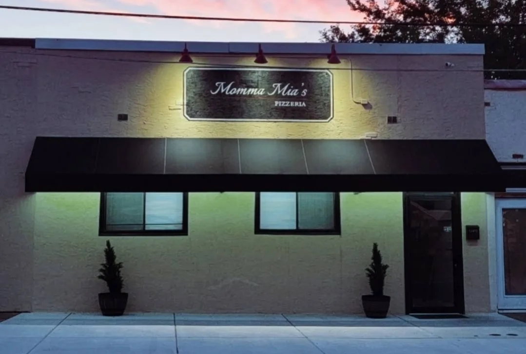 Exterior of Momma Mia's Pizzeria with warm lighting