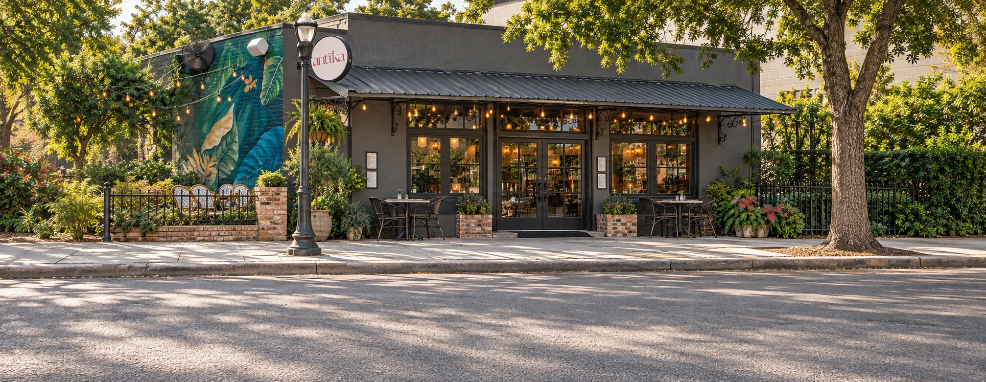 Charming restaurant exterior with lush greenery and artistic mural
