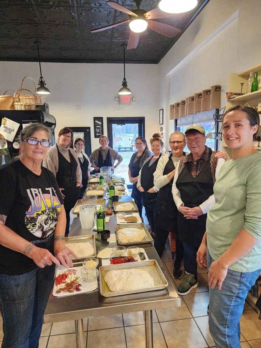 Group cooking class preparing artisan bread in a cozy kitchen