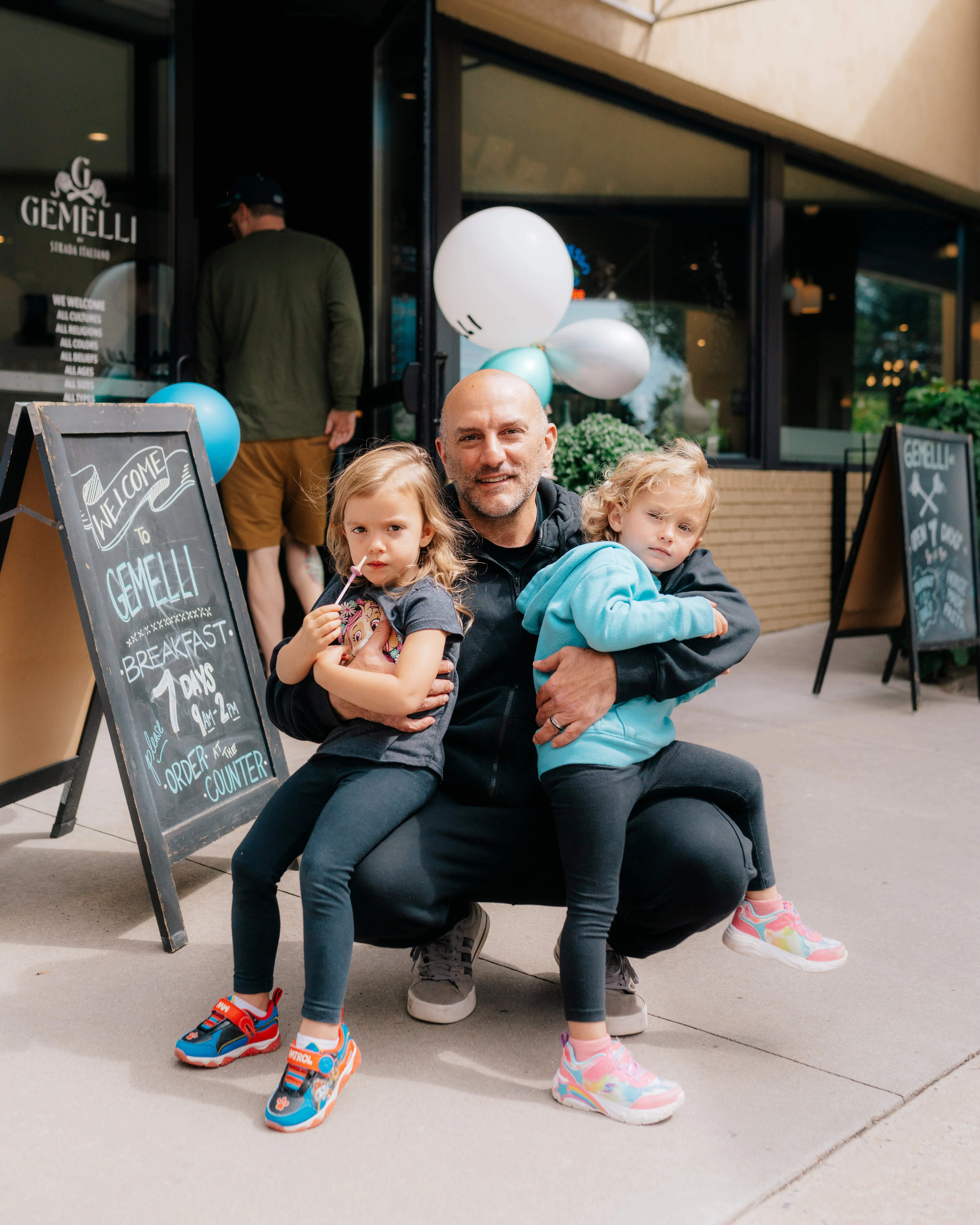Family enjoying time outside Gemelli restaurant