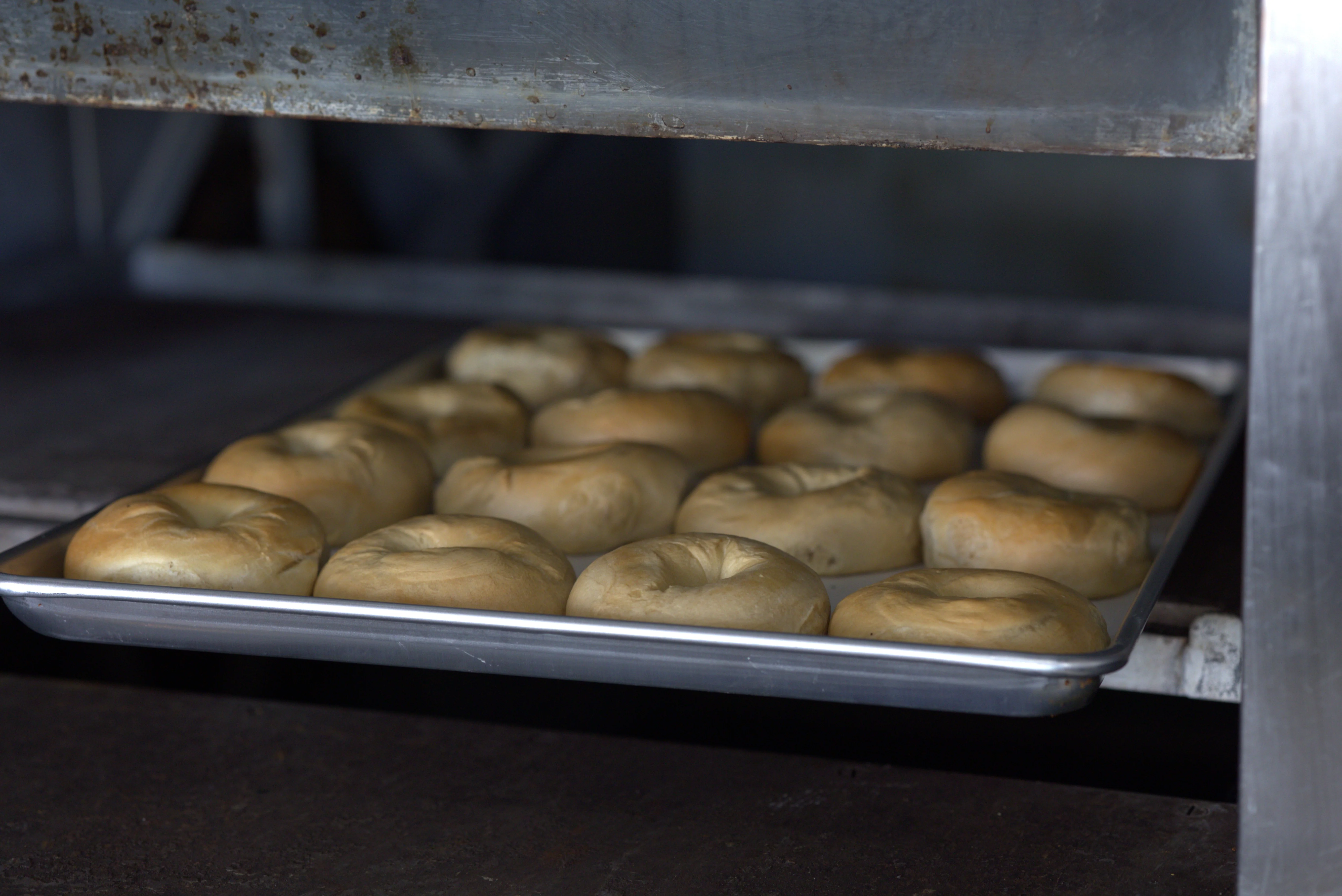 Freshly baked bagels cooling on a tray