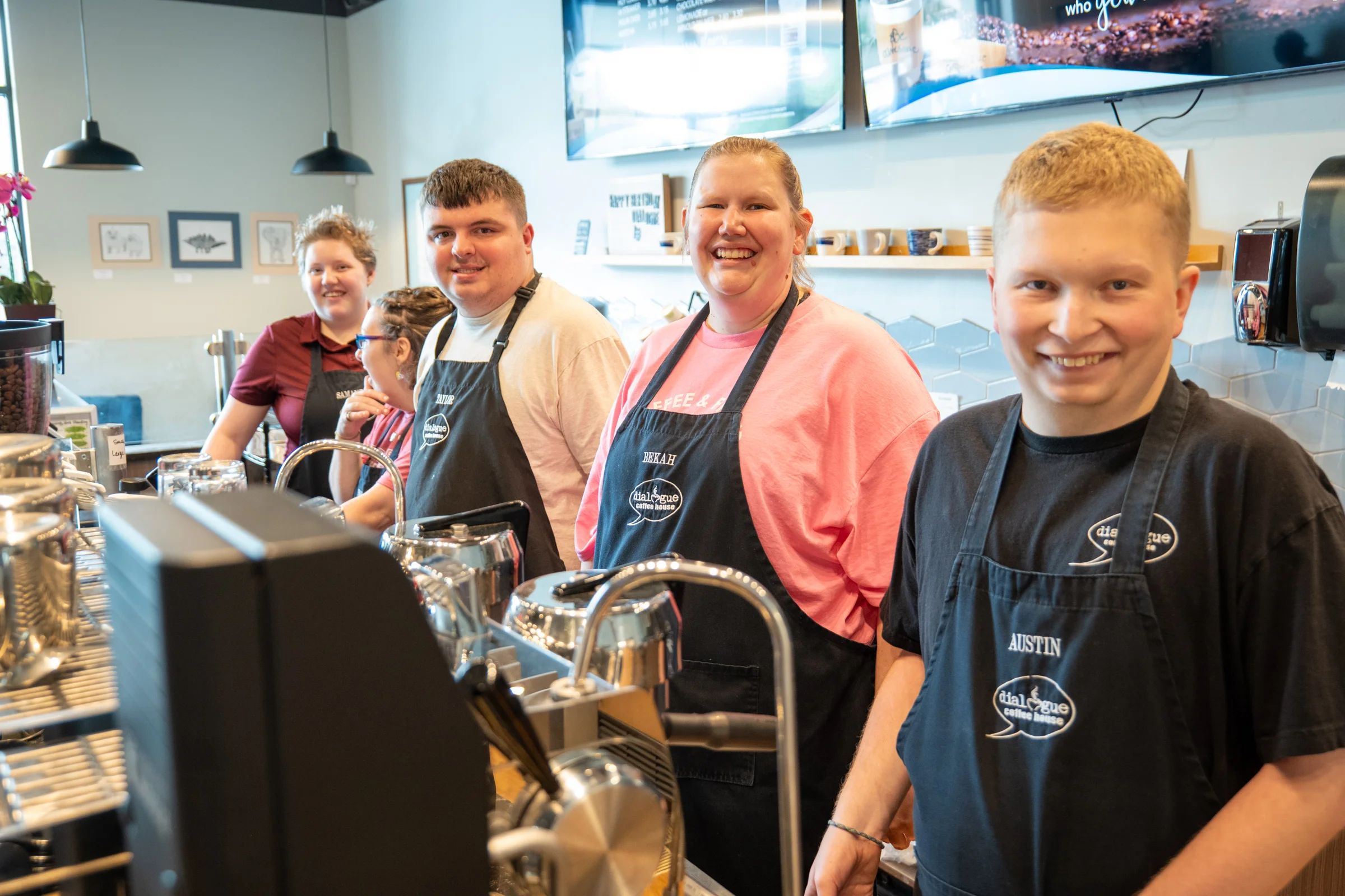 Barista smiling in a cozy coffee shop interior