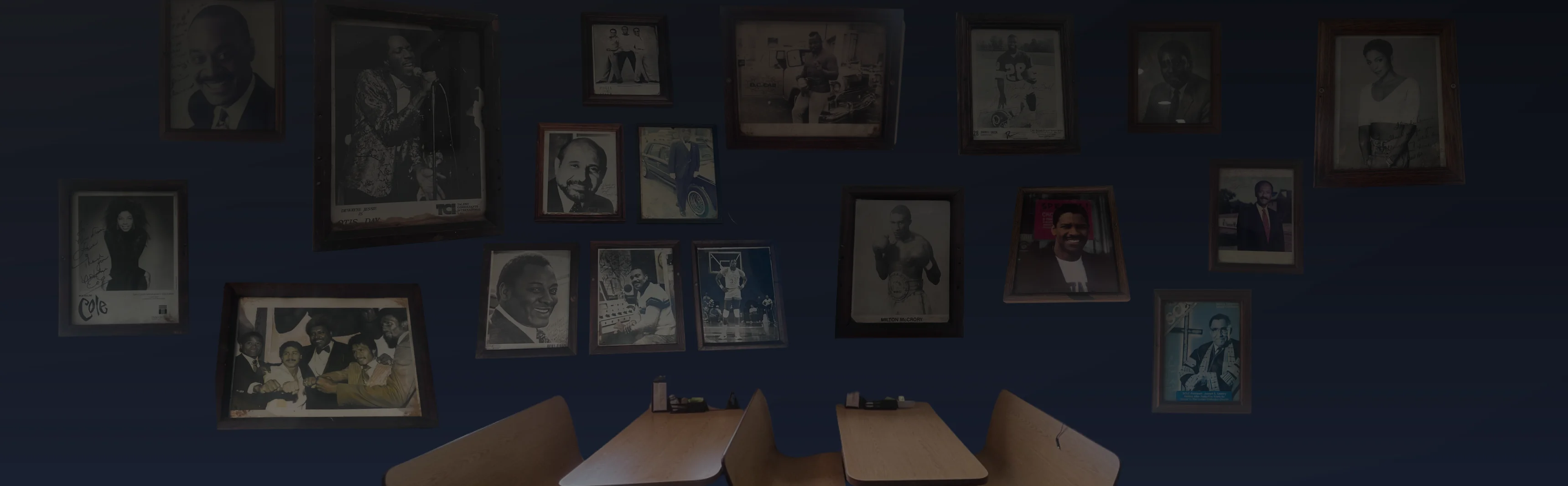 Restaurant dining room with framed historical portraits and wooden tables
