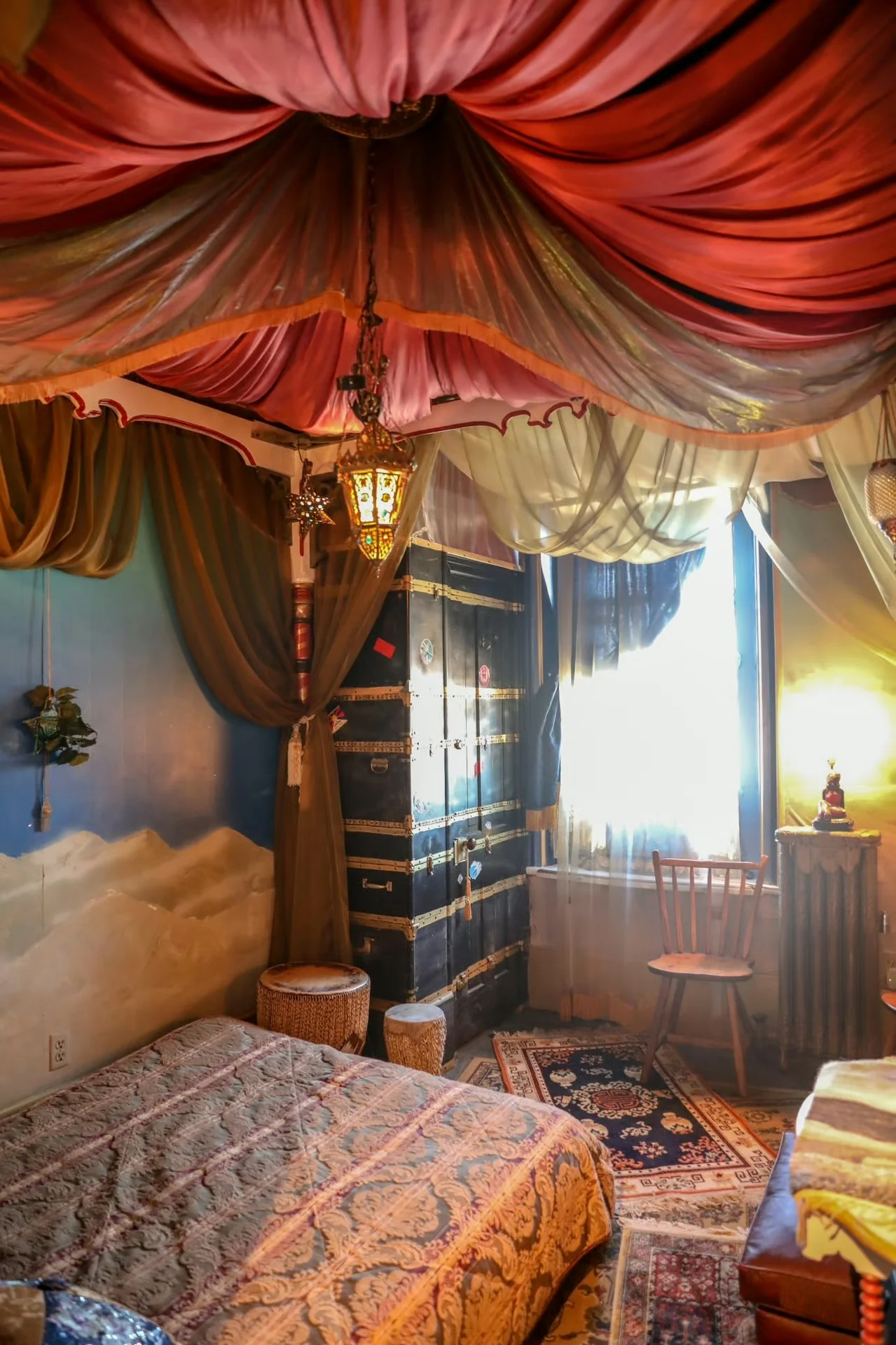 Bohemian-style bedroom with colorful drapery and vintage decor