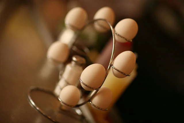 Stylish egg holder with white eggs in a modern restaurant setting