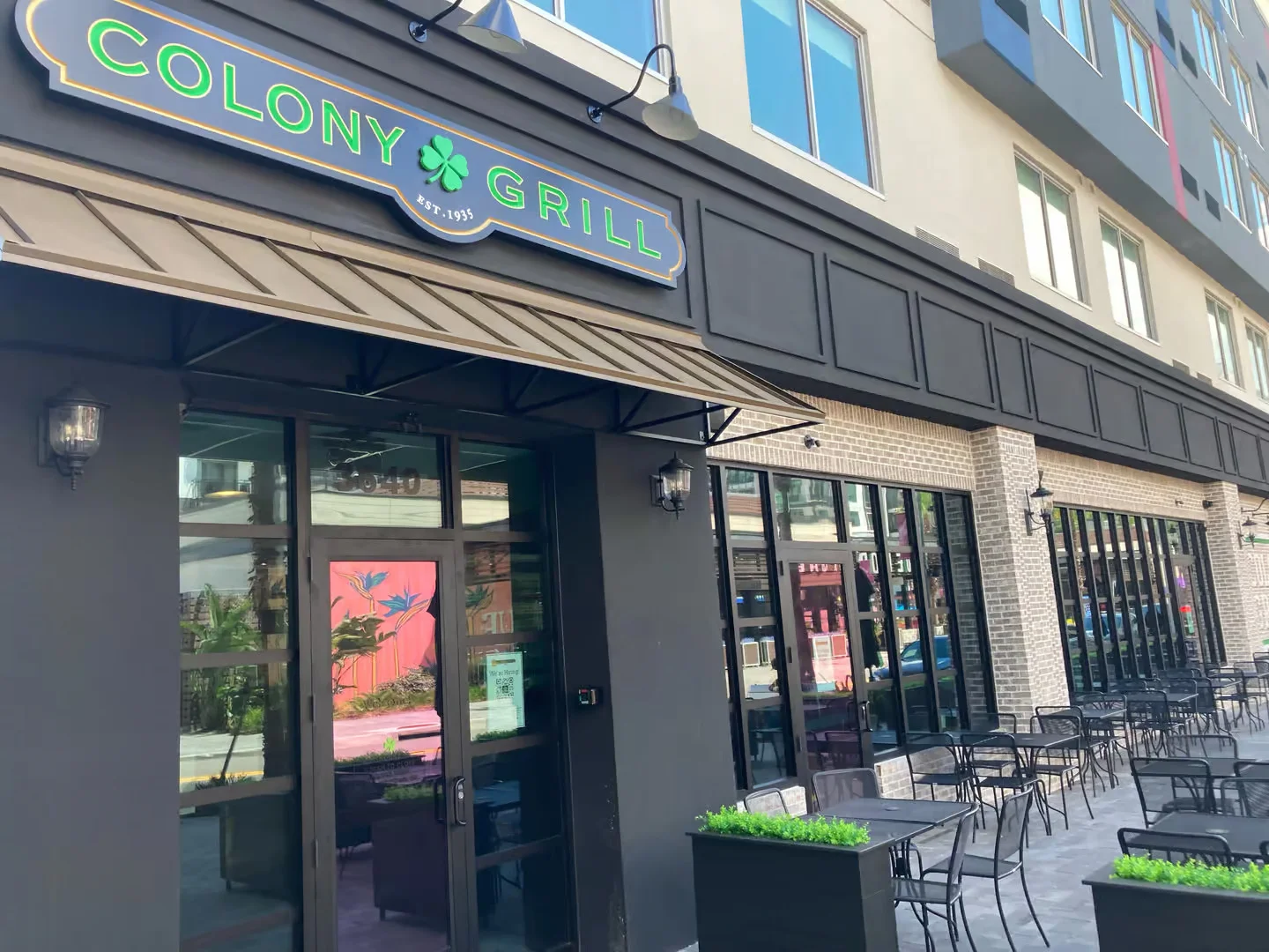 Exterior view of Colony Grill restaurant with outdoor seating