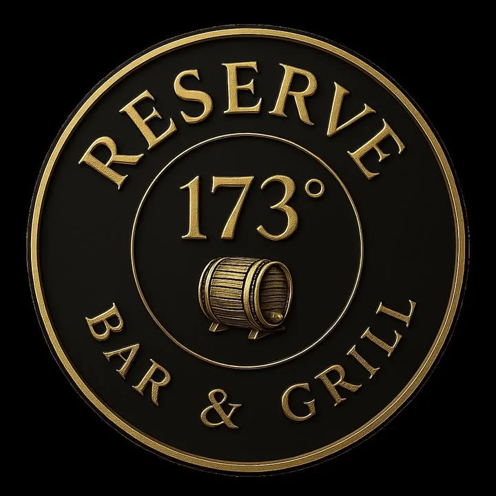 The exterior view of a craft distillery with a circular sign displaying its name. The entrance features wooden paneling and a small American flag.