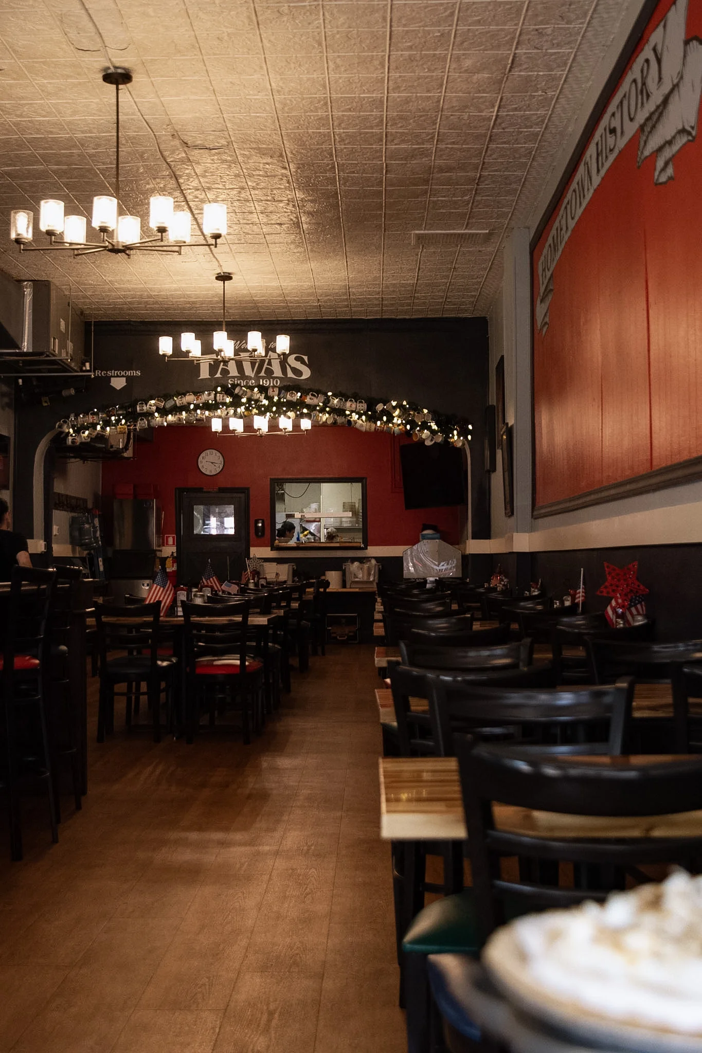 Cozy restaurant interior with warm lighting and wooden tables