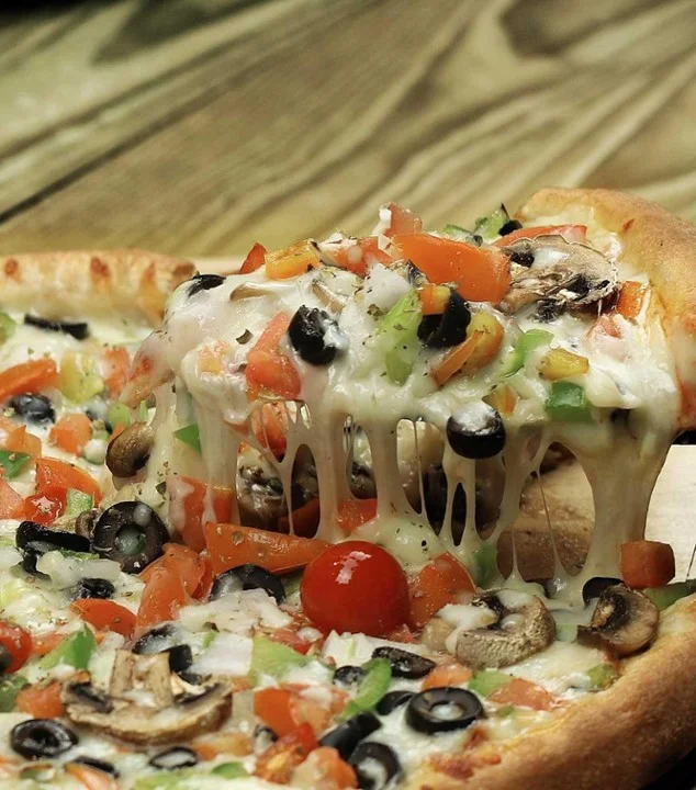 Vegetarian pizza with melted cheese and fresh toppings