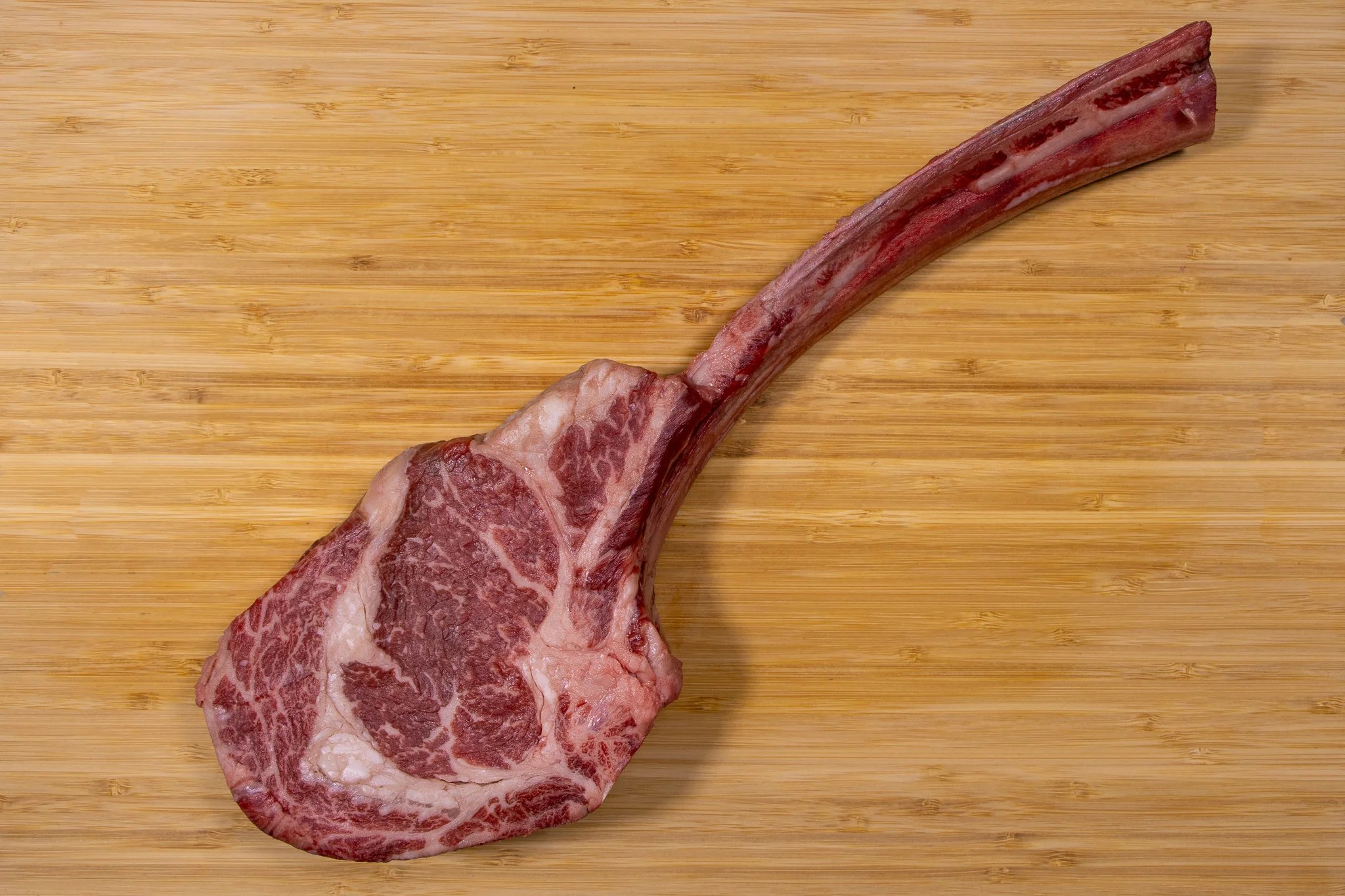 Tomahawk steak on a wooden cutting board