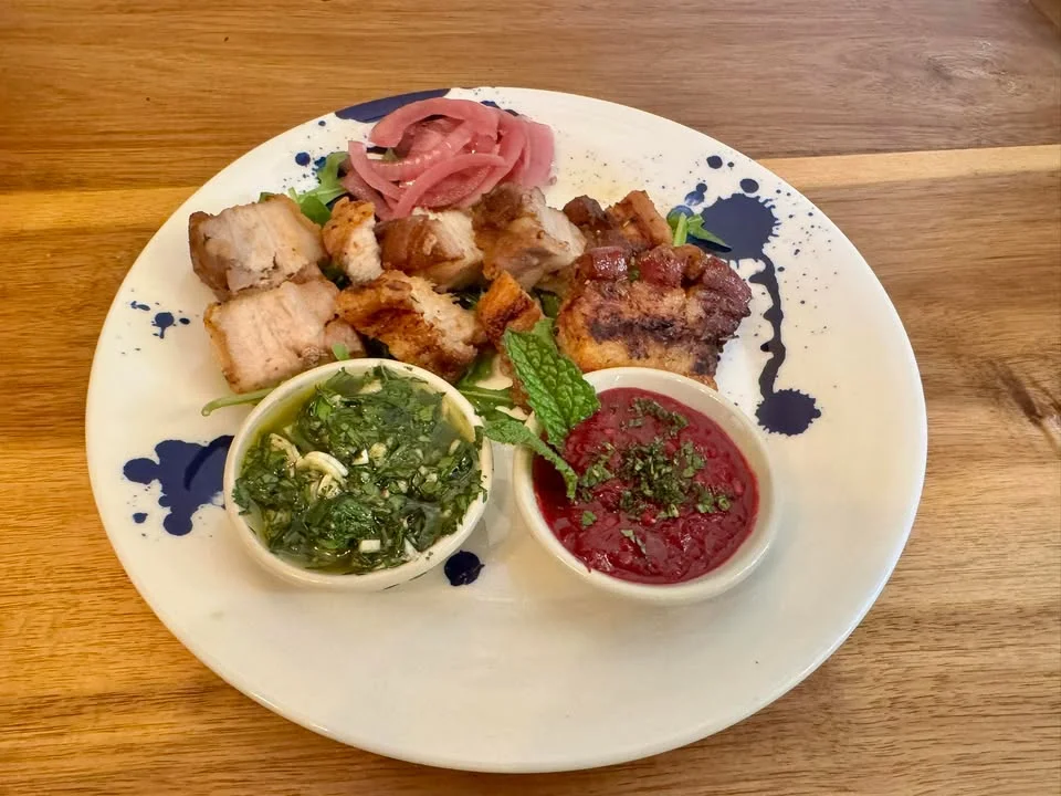 Peruvian anticuchos with dipping sauces and pickled onions