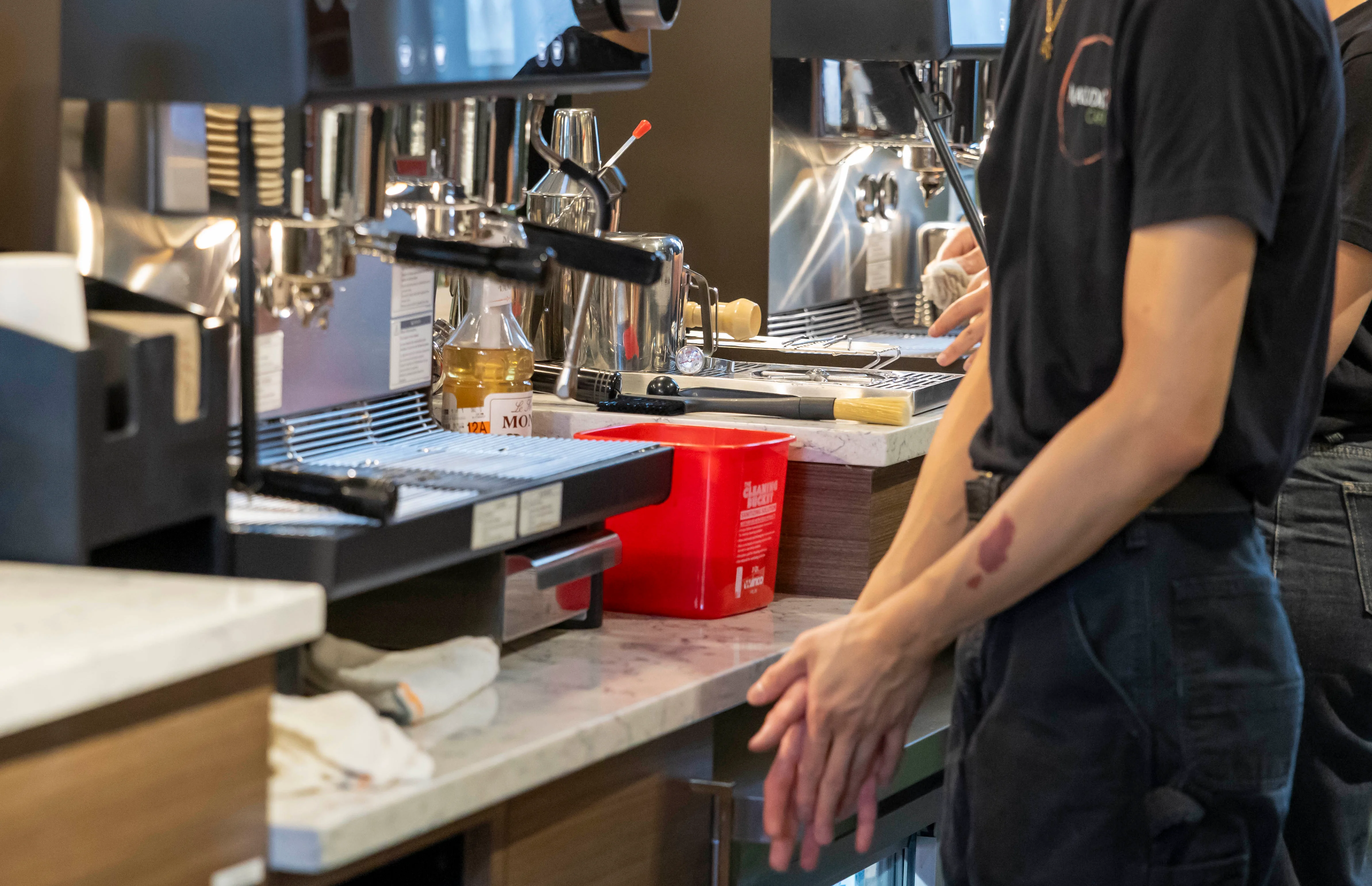 Baristas preparing coffee at a modern café counter
