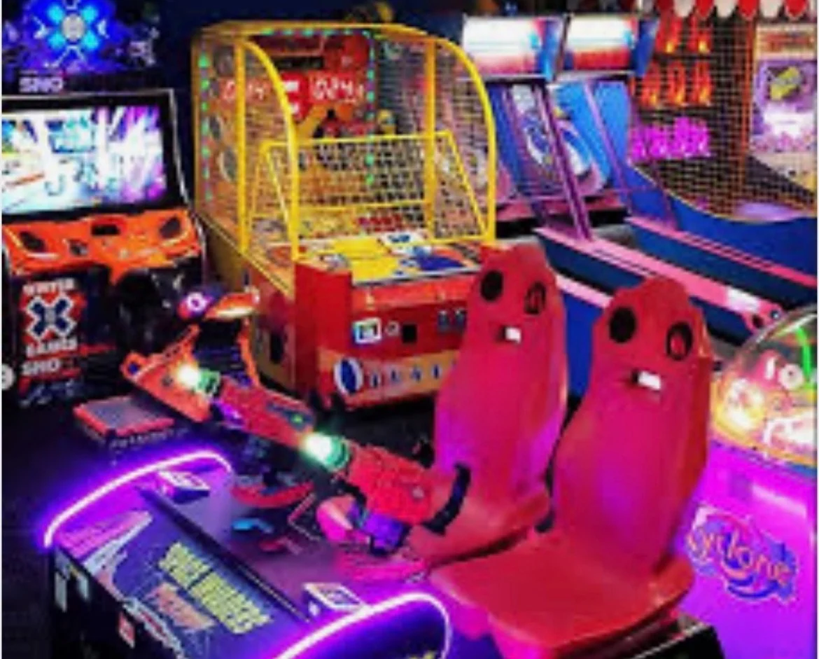 Colorful arcade games with vibrant lighting and seating