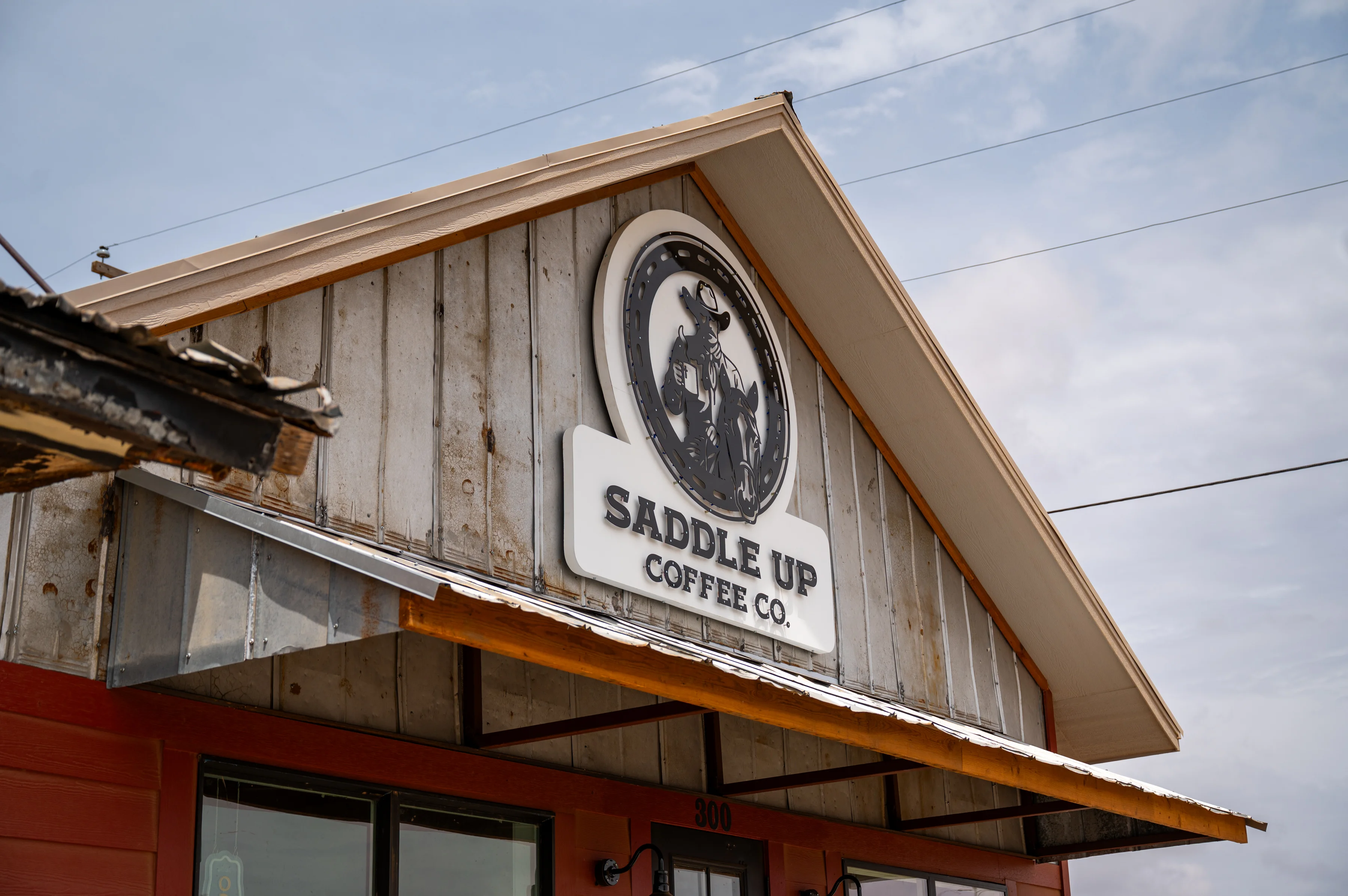 Exterior of Saddle Up Coffee Co. with rustic wooden design